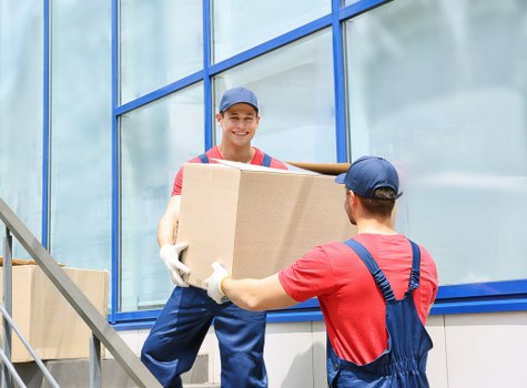 Removals team preparing a safe move with packing and lifting equipment
