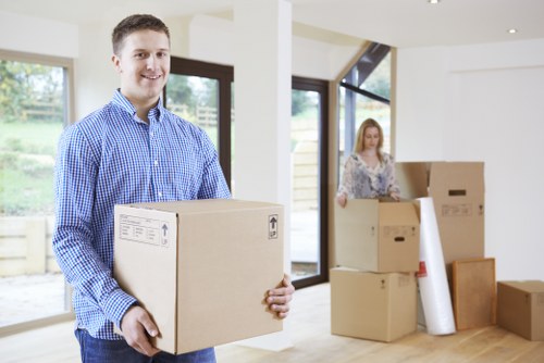 Trained movers carefully handling furniture with protective packing