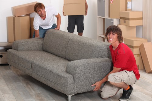Furniture and boxes being loaded into a moving truck in Ilford