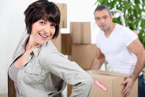 Careful transport of a piano through a residential property with narrow access