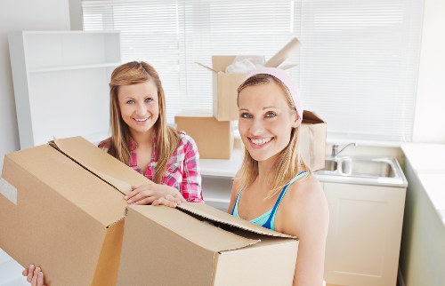 Removal staff managing stairs and access during an Ilford flat move