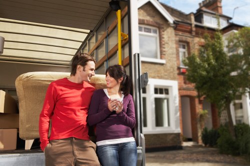 Professional moving team handling furniture and boxes in Ilford